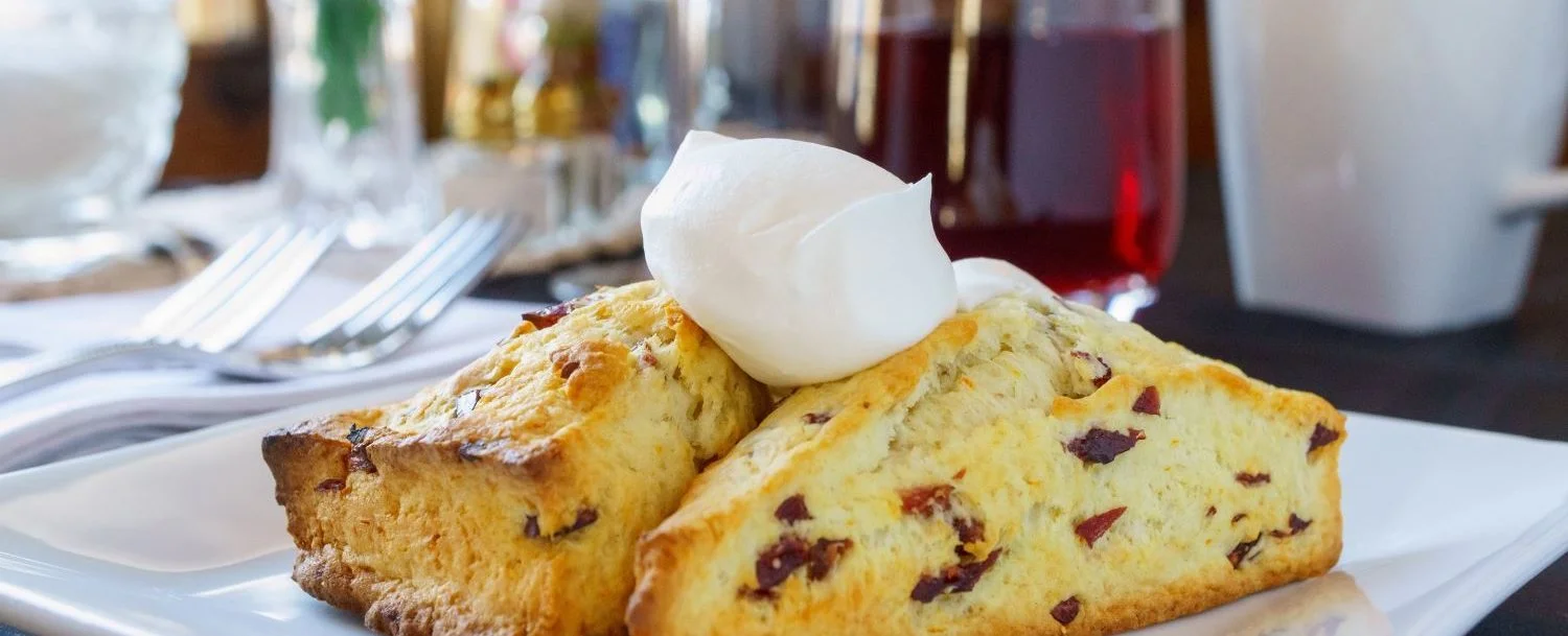 Scones on a plate with butter on top