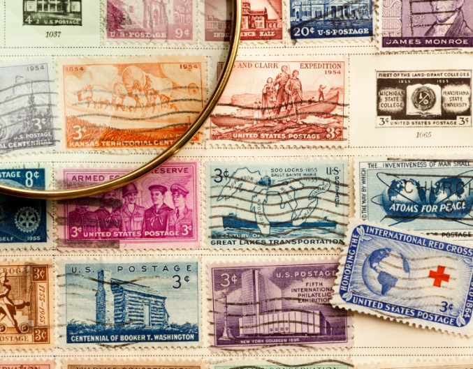 Magnifying glass with stamps in the background